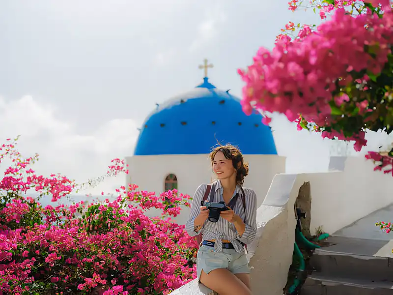 Iconic white houses with blue domes overlooking the sea on Santorini island Greece.