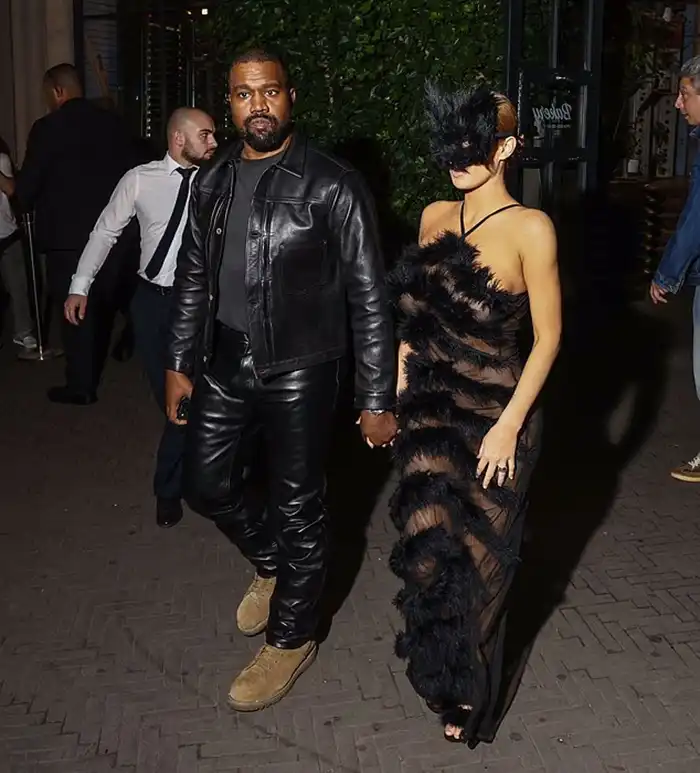 A Wild Night Out: Bianca Censori Goes Completely Braless in a Jaw-Dropping Sheer Getup and a Furry Headpiece on an Intimate Date Night with Kanye West MODISTA Kanye West and Bianca Censori holding hands while walking outside a luxury resort.