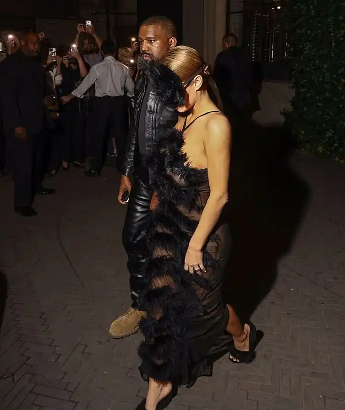 A Wild Night Out: Bianca Censori Goes Completely Braless in a Jaw-Dropping Sheer Getup and a Furry Headpiece on an Intimate Date Night with Kanye West MODISTA Bianca Censori walking hand-in-hand with Kanye West wearing a transparent black dress and a furry cat mask.